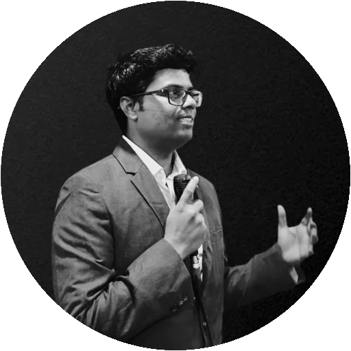 Sunil Kumar speaking on stage, black and white